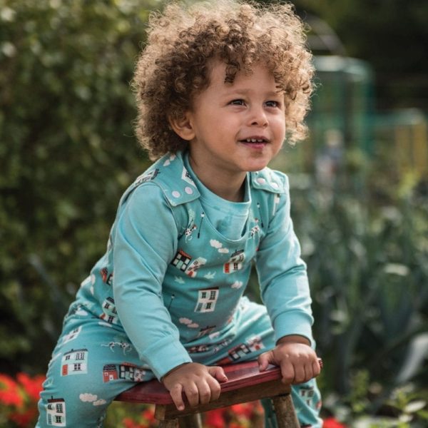 Toddler wearing house print dungarees from Cotton Boulevard