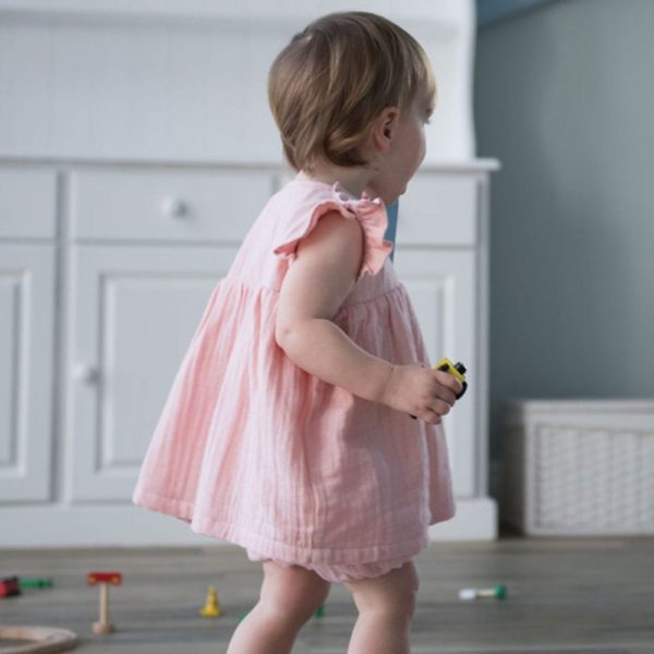 Toddler playing in pink dress